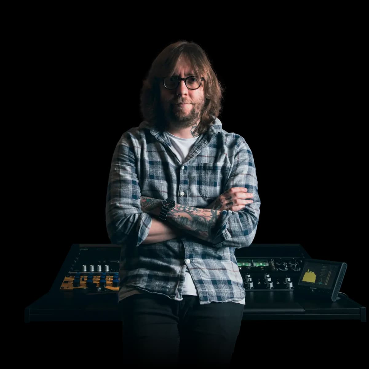 Graeme leaning on a mixing desk.